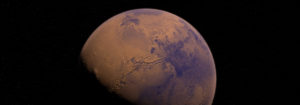 Orange and blue tinted photo of the planet Mars, partly in shadow