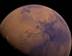 Orange and blue tinted photo of the planet Mars, partly in shadow