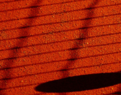 Tennis ball in the shadow of the court net