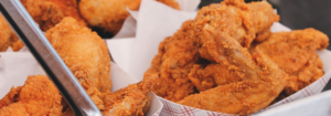 Paper plates of fried chicken